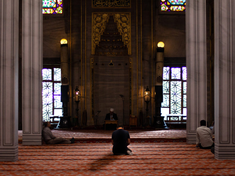 Image of man praying in a mosque
