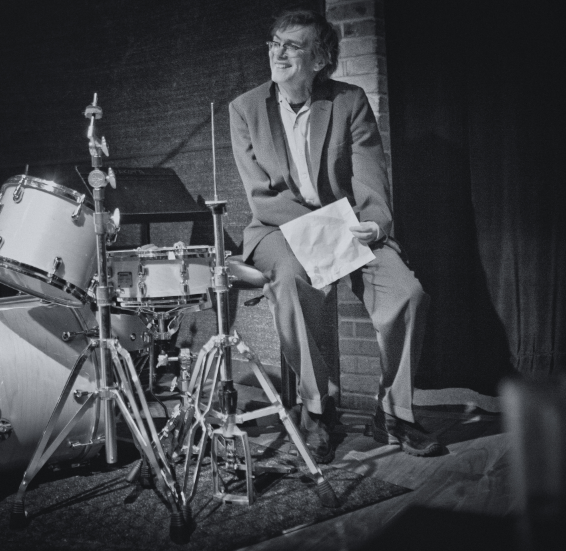 Kevin Kling sits by a drum set