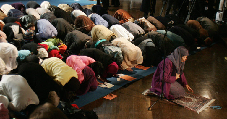 On March 18, 2005, Amina Wadud (right, kneeling), a professor of Islamic studies at Virginia Commonwealth University, leads both men and women in prayer at Synod House at the Cathedral of St. John the Divine in New York. Her action has drawn sharp criticism from Muslim religious leaders.