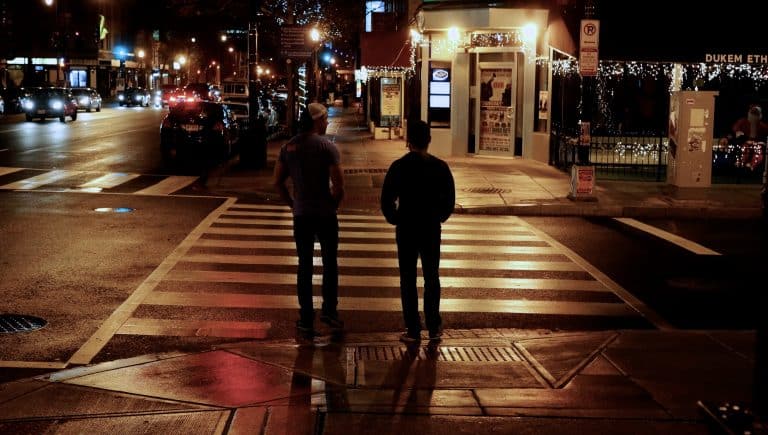 people walking on street at night