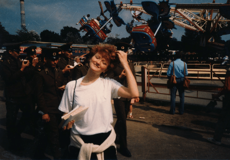 Krista Tippett stands in front of an amusement park in Germany in the 1980s.