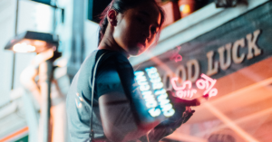 Woman looks over her shoulder in front a city street.