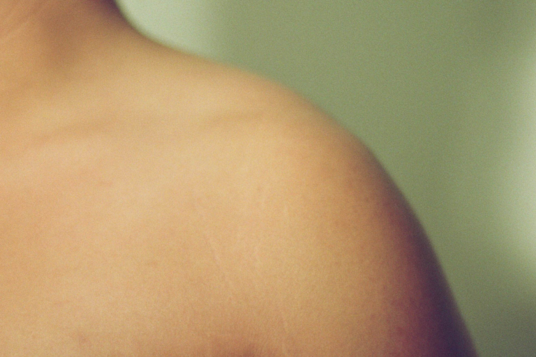 A close up of a bare shoulder and collar bone.